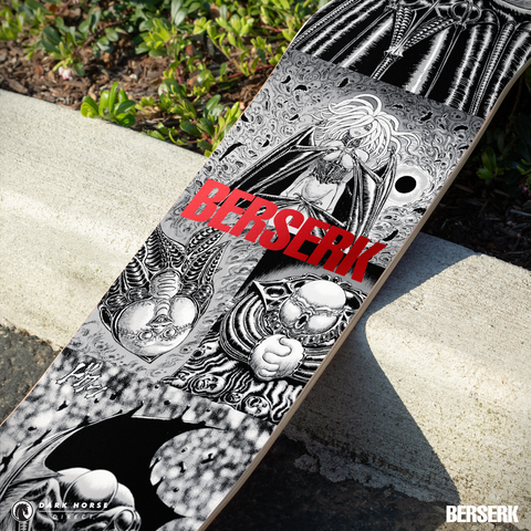 Closeup skateboard deck with 'Berserk' red foil variant design and text on a concrete surface